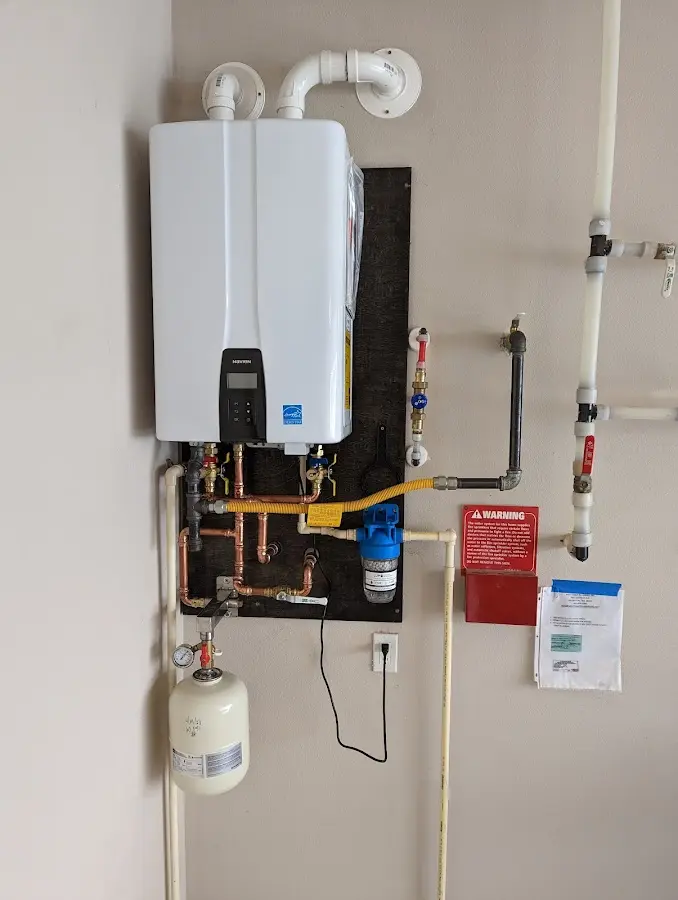 Professional plumber installing copper piping in a Buckner home
